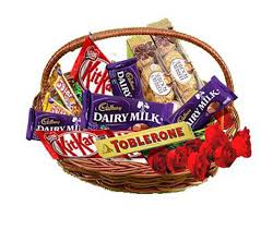 Cadburys mixed chocolates in a basket with 5 roses
