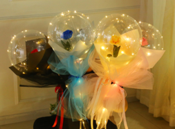 Four Transparent bobo balloons with roses inside and LED Light for anniversary celebration