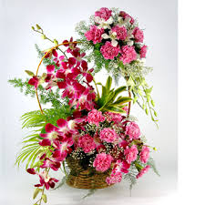 10 orchids with carnations in basket and carnations on handle arrangement