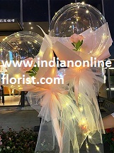 2 Pink rose in 2 transparent balloon arrangement with fairy light White wrapping Only for Pune and Mumbai