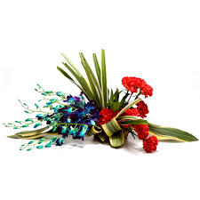 A basket of 4 Blue orchids and 8 Red carnations